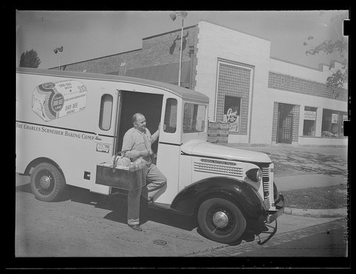 Untitled photo, possibly related to: Washington, D.C. A Charles Schneider Baking Company delivery truck displaying a United States Truck Conservation Corps pledge, showing a driver alighting with a basket of bread