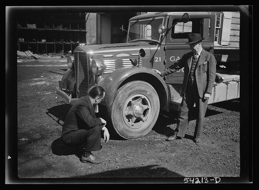 Untitled photo, possibly related to: Washington, D.C. A Galliher and Huguely, Inc. truck, showing two men looking at one of the tires