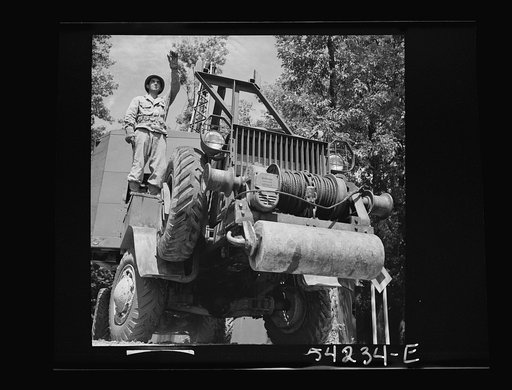 Untitled photo, possibly related to: Fort Belvoir, Virginia. A soldier on a truck with a mounted crane