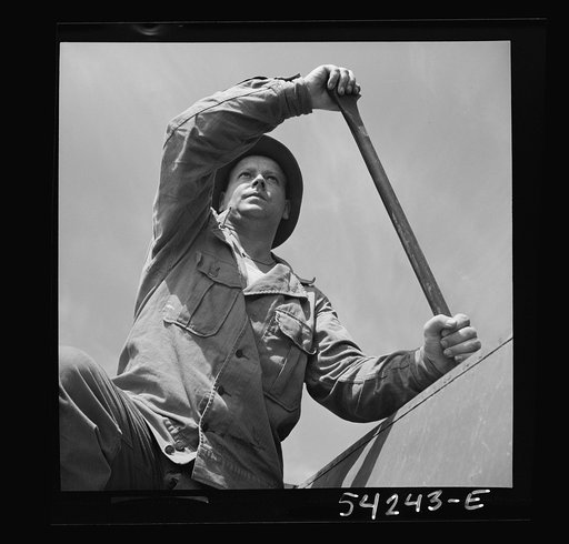 Untitled photo, possibly related to: Fort Belvoir, Virginia. A soldier of the United States Army engineer corps paddling a barge