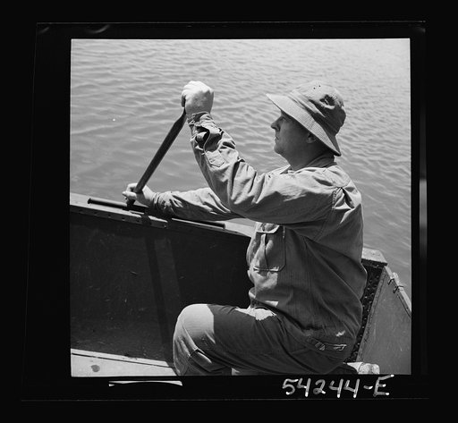 Fort Belvoir, Virginia. A soldier of the United States Army Engineer Corps paddling a barge