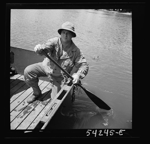 Untitled photo, possibly related to: Fort Belvoir, Virginia. Four soldiers of the United States Army Engineer Corps paddling a barge, probably for the construction of a bridge