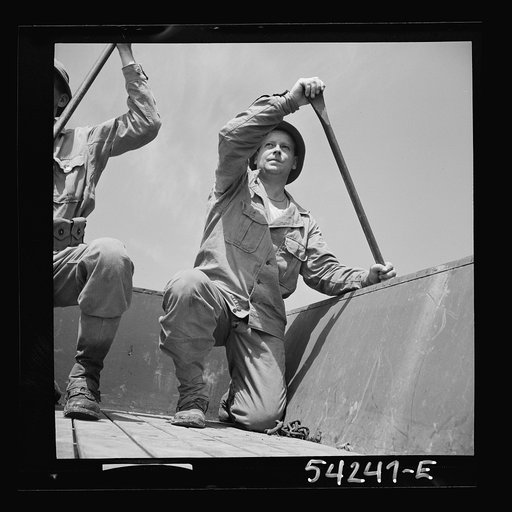Untitled photo, possibly related to: Fort Belvoir, Virginia. Four soldiers of the United States Army Engineer Corps paddling a barge, probably for the construction of a bridge