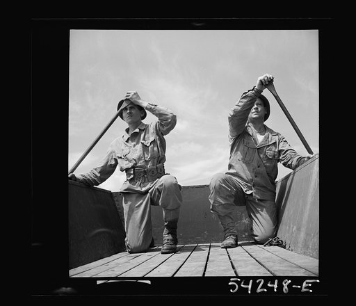Untitled photo, possibly related to: Fort Belvoir, Virginia. Four soldiers of the United States Army Engineer Corps paddling a barge, probably for the construction of a bridge
