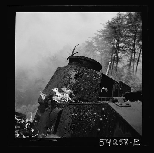 Fort Belvoir, Virginia. A burning armored tank, showing the effects of a hit by a "Molotov cocktail" grenade