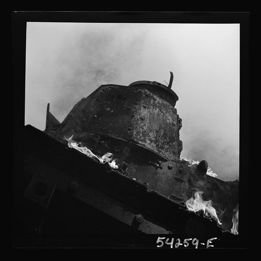 Fort Belvoir, Virginia. A burning armored tank, showing the effects of a hit by a "Molotov cocktail" grenade