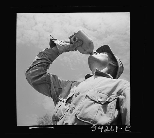 Untitled photo, possibly related to: Fort Belvoir, Virginia. A soldier drinking from a G.I. water canteen