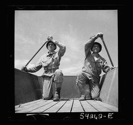 Untitled photo, possibly related to: Fort Belvoir, Virginia. Two soldiers of the United States Army Engineer Corps paddling a barge