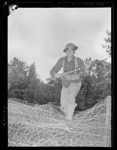 Fort Belvoir, Virginia. A United States Army Engineer Corps soldier going over a wire barricade