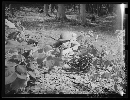Fort Belvoir, Virginia. A soldier on the ground practicing with a rifle