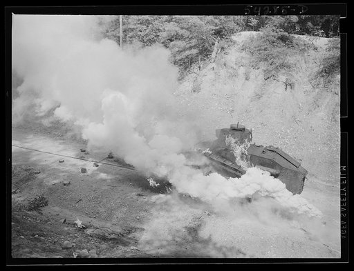 Fort Belvoir, Virginia. A burning armored tank, showing the effects of a hit by a "Molotov cocktail" grenade