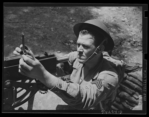 Fort Belvoir, Virginia. A sergeant in the United States Army Engineer Corps adjusting the sight of a machine gun
