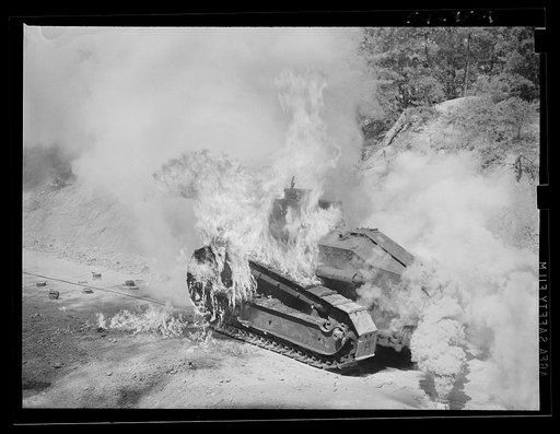 Fort Belvoir, Virginia. A burning armored tank, showing the effects of a hit by a "Molotov cocktail" grenade