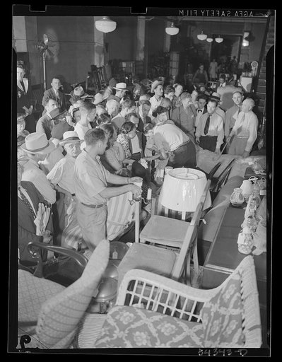 Untitled photo, possibly related to: Washington, D.C. A crowd of people examining furniture to be sold at the Adam A. Weschler & Son auction sale