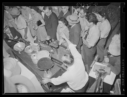 Washington, D.C. A crowd listening to an auctioneer at the Adam A. Weschler & Son store