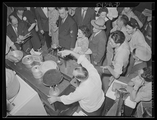 Washington, D.C. A view looking down upon the auctioneer and crowd at an Adam A. Weschler & Son sale