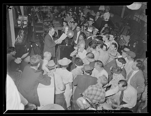 Washington, D.C. A crowd listening to an auctioneer in the Adam A. Weschler & Son store