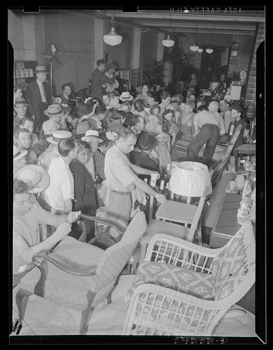 Washington, D.C. A crowd of people examining furniture to be sold at the Adam A. Weschler & Son auction sale