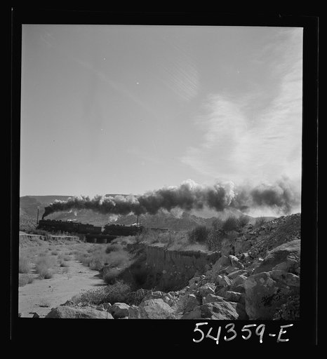 Kingman (vicinity), Arizona. A transcontinental train passing close to the tungsten recovery plant where the ore from the Boriana mines is processed