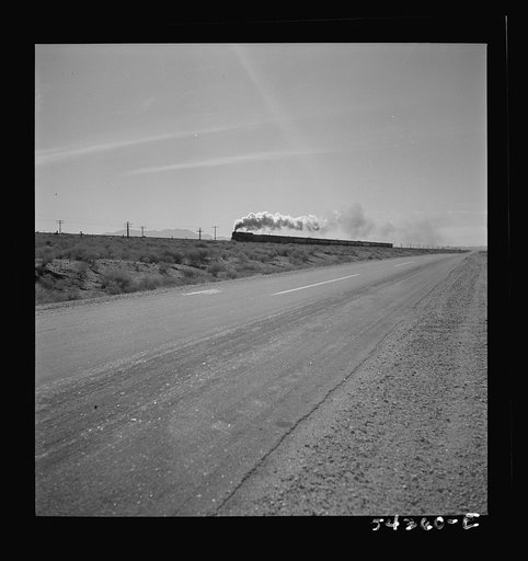 Kingman (vicinity), Arizona. A transcontinental train passing close to the tungsten recovery plant where the ore from the Boriana mines is processed