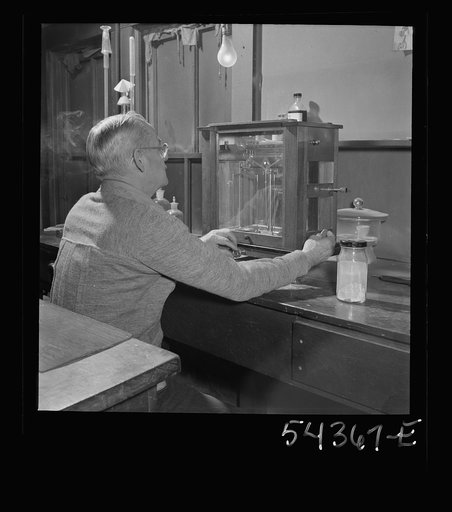 Untitled photo, possibly related to: Kingman (vicinity), Arizona. Mr. Relling, in the laboratory, analyzing tungsten ore and concentrates in a plant near the Boriana mines where the chromium-like metallic elements are obtained