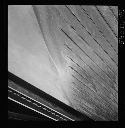 Kingman (vicinity), Arizona. Tungsten ore concentrating on tables in a recovery plant near the Boriana mine. There are many vital uses for this ore in the war effort