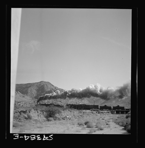 Kingman (vicinity), Arizona. A transcontinental train passing close to the tungsten recovery plant where the ore, obtained from the Boriana mines, is processed