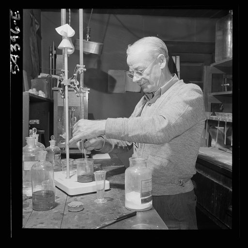 Untitled photo, possibly related to: Kingman (vicinity), Arizona. Mr. Relling, in the laboratory, analyzing tungsten ore and concentrates in a plant near the Boriana mines where the chromium-like metallic elements are obtained