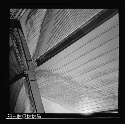 Untitled photo, possibly related to: Kingman (vicinity), Arizona. Tungsten ore concentrating on tables in a recovery plant near the Boriana mine. There are many vital uses for this ore in the war effort