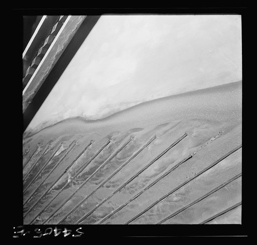 Untitled photo, possibly related to: Kingman (vicinity), Arizona. Tungsten ore concentrating on tables in a recovery plant near the Boriana mine. There are many vital uses for this ore in the war effort