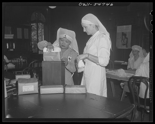 Filipino American Red Cross surgical dressing unit, Washington, D.C. Left to right: Mrs. Conchita Perez and Mrs. J. Weldon Jones, wife of former insular auditor and acting high commissioner of Philippines for year and a half