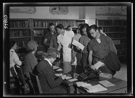 Blood donors at San Quentin line up to fill in donor applications upon arrival of the Red Cross mobile unit. Medical histories are checked by Red Cross workers before blood can be given