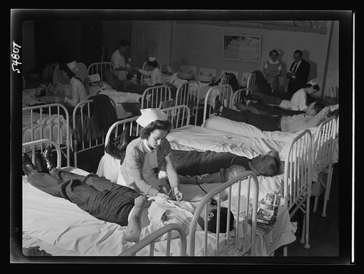 Mrs. Evelyn Hauser, Red Cross nurse, prepares a volunteer blood donor at San Quentin for his donation. During the Red Cross mobile unit's visit to the penitentiary, 150 prisoners gave blood and more than twice that number volunteered but were unable to give to the bank because of lack of time and eq