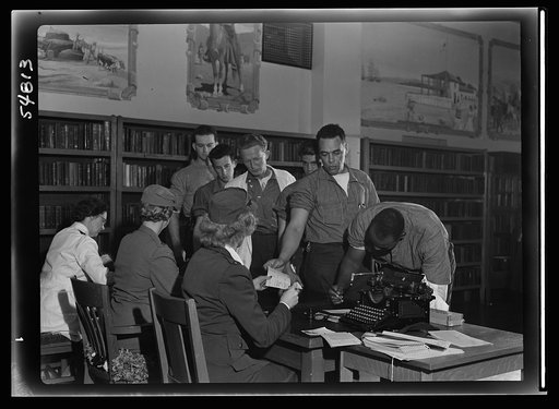 Blood donors at San Quentin line up to fill the donor applications upon arrival of the Red Cross mobile unit. Medical histories are checked by Red Cross workers before blood can be given