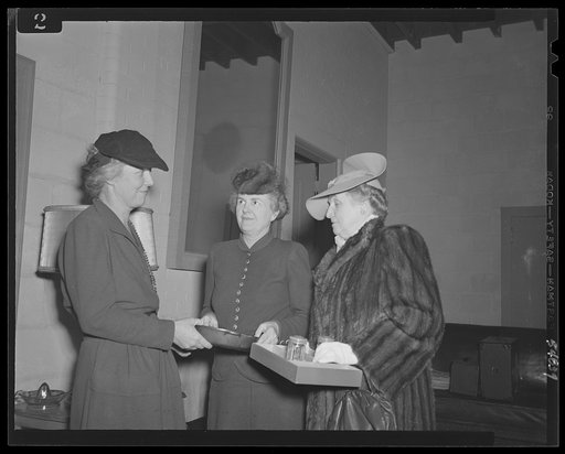 Washington, D.C. Mrs. James M. Landis, Mrs. Henry Wallace, and Mrs. Jesse Jones admiring gifts at the kitchen shower at the Walsh Club for war workers