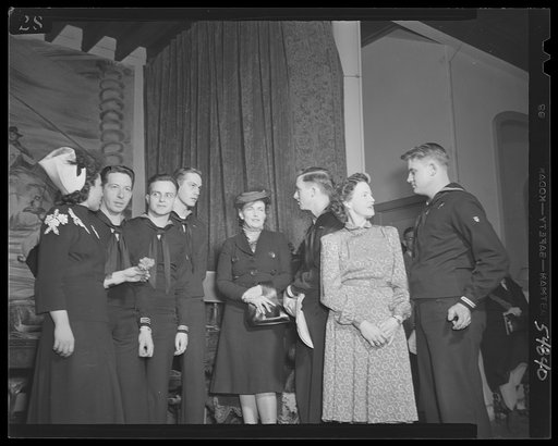 Washington, D.C., Mrs. James M. Landis, Mrs. James Forrestal, center, with the enlisted personnel of the Navy School of Music, who performed at the kitchen shower of the Walsh Club for war workers, and other artists who contributed their talent. Left to right: Mrs. Virginia Varney, singer; Thomas Pa