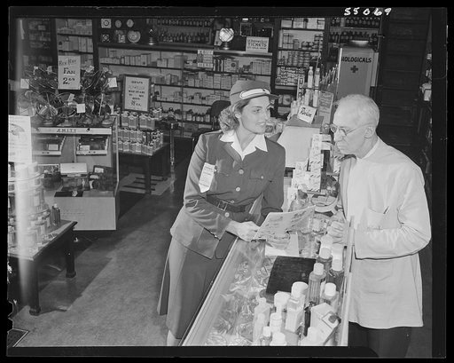 New York (and vicinity), New York. Miscellaneous photograph relating to the war effort. Woman volunteer checking and posting ceiling prices for the U.S. Office of Price Administration (OPA)
