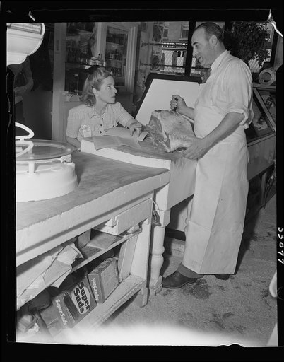 New York (and vicinity), New York. Miscellaneous photograph relating to the war effort. Woman volunteer checking and posting ceiling prices for the U.S. Office of Price Administration (OPA)