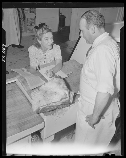New York (and vicinity), New York. Miscellaneous photograph relating to the war effort. Woman volunteer checking and posting ceiling prices for the U.S. Office of Price Administration (OPA)