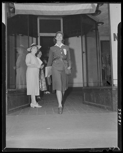 New York (and vicinity), New York. Miscellaneous photograph relating to the war effort. Woman volunteer checking and posting ceiling prices for the U.S. Office of Price Administration (OPA)