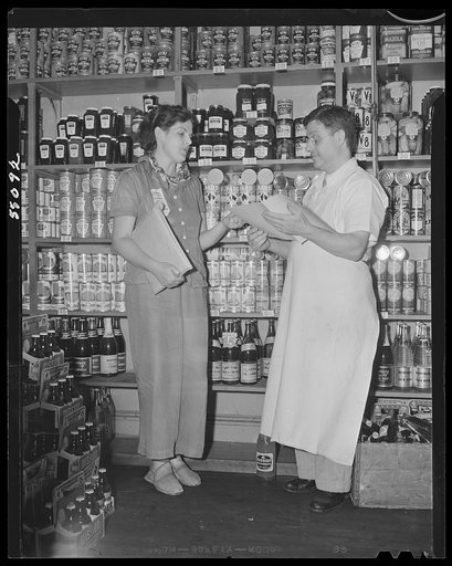 New York (and vicinity), New York. Miscellaneous photograph relating to the war effort. Woman volunteer checking and posting ceiling prices for the U.S. Office of Price Administration (OPA)