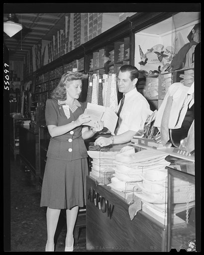 New York (and vicinity), New York. Miscellaneous photograph relating to the war effort. Woman volunteer checking and posting ceiling prices for the U.S. Office of Price Administration (OPA)