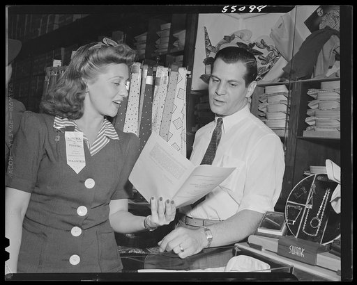 New York (and vicinity), New York. Miscellaneous photograph relating to the war effort. Woman volunteer checking and posting ceiling prices for the U.S. Office of Price Administration (OPA)