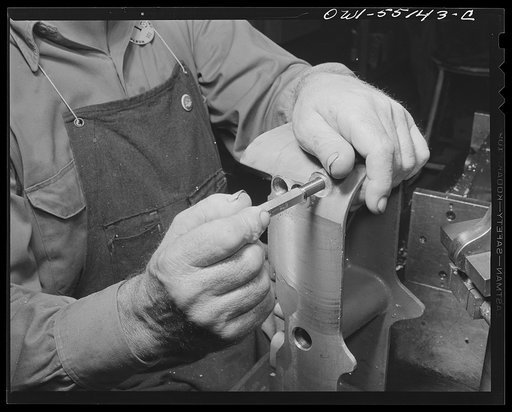 North American Aviation, Inc., Inglewood, California. Hands of a skilled machinist working on a part for a B-25 bomber or P-51 fighter