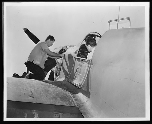 A North American P-51 fighter is given final inspection before its first test flight