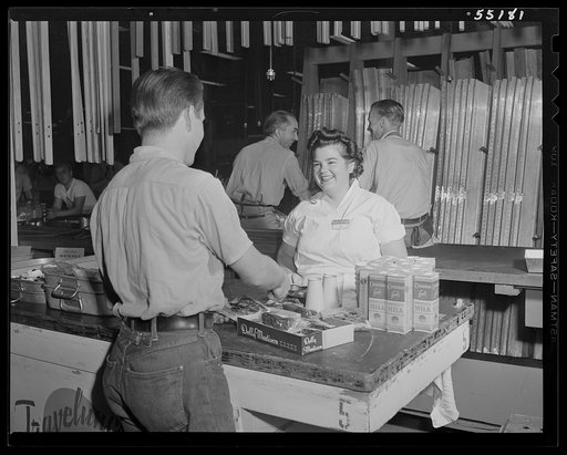 An employee buys lunch at one of the "Travelunch" wagons that are stationed throughout the plant at North American
