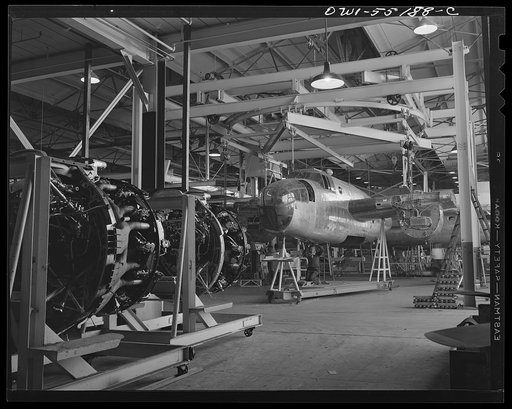 At the end of the overhead conveyer line an overhead turntable enables the forward and rear fuselage sections to be attached to the North American B-25 bomber before it moves to the final assembly line