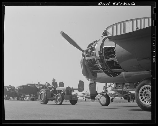 North American B-25 bombers are moved to their position on the flight ramp by a small tractor