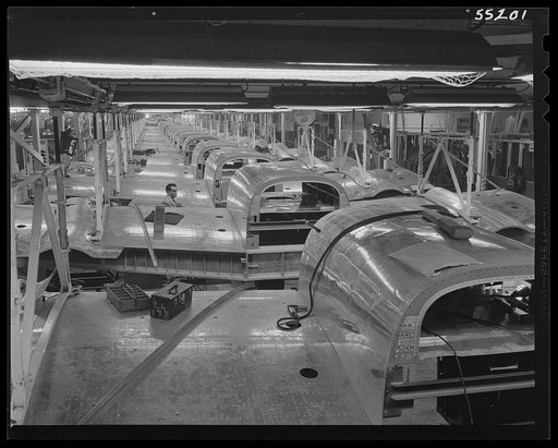 This powered overhead conveyor line at North American Aviation carries B-25 center sections