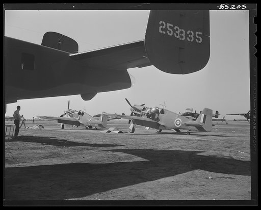 North American P-51 fighters and B-25 bombers await test flights and delivery on North American's flight ramp